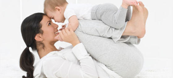 Ethnic mom and baby playing on floor