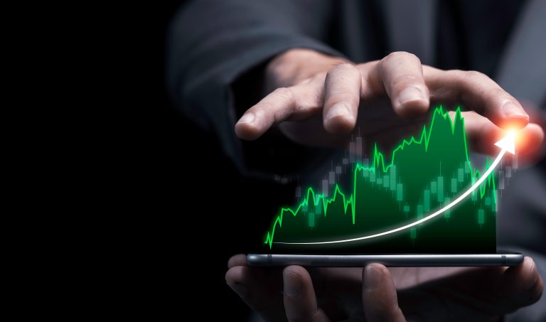 Economic,And,Profit,Investment,Growth,Concept,,,Businessman,Holding,Smartphone