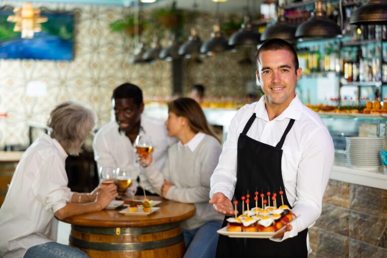 Smiling,Waiter,Posing,And,Holding,Tray,With,Order,At,Beer