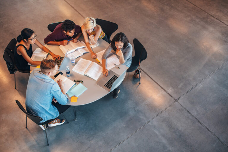 Multiracial,Group,Of,Young,Students,Studying,Together.,High,Angle,Shot