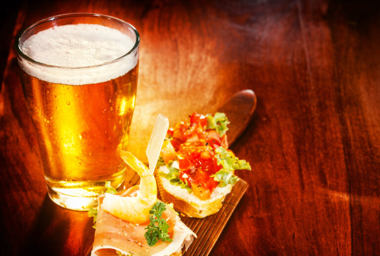 Glass,Of,Cold,Beer,With,Delicious,Tapas,Topped,With,Shrimp,