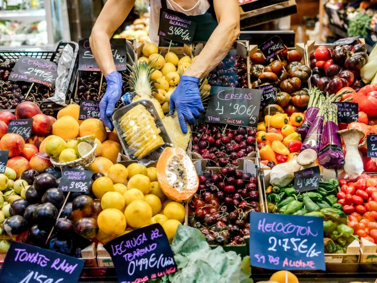 Woman,Placing,Fruit,In,A,Greengrocer's,Shop.,The,Photo,Shows