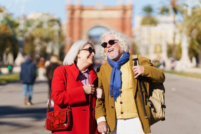 Senior,Tourist,Couple,Laughing,Outdoors,While,Visiting,City.